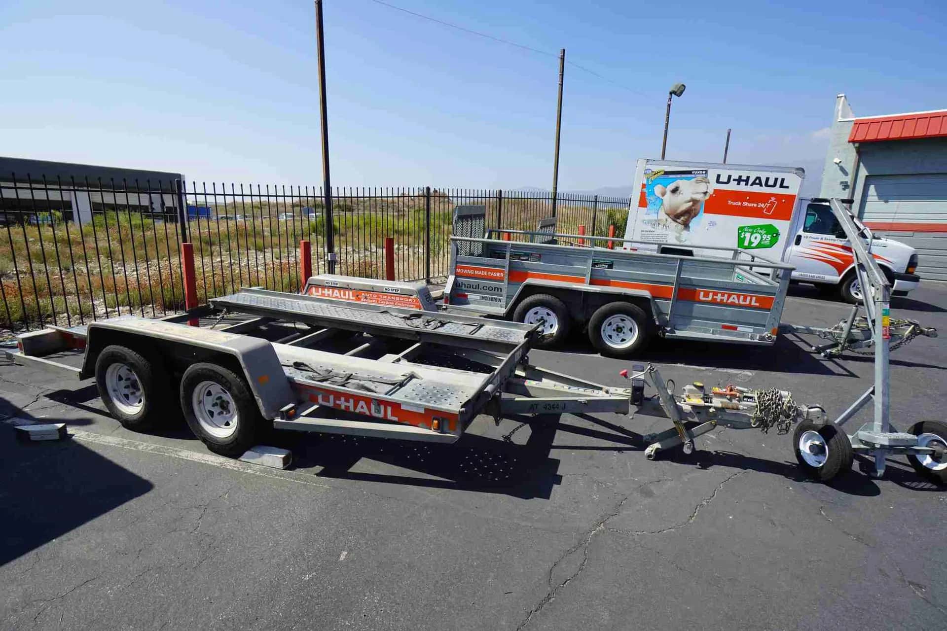 U-Haul car trailer and truck parked on the lot
