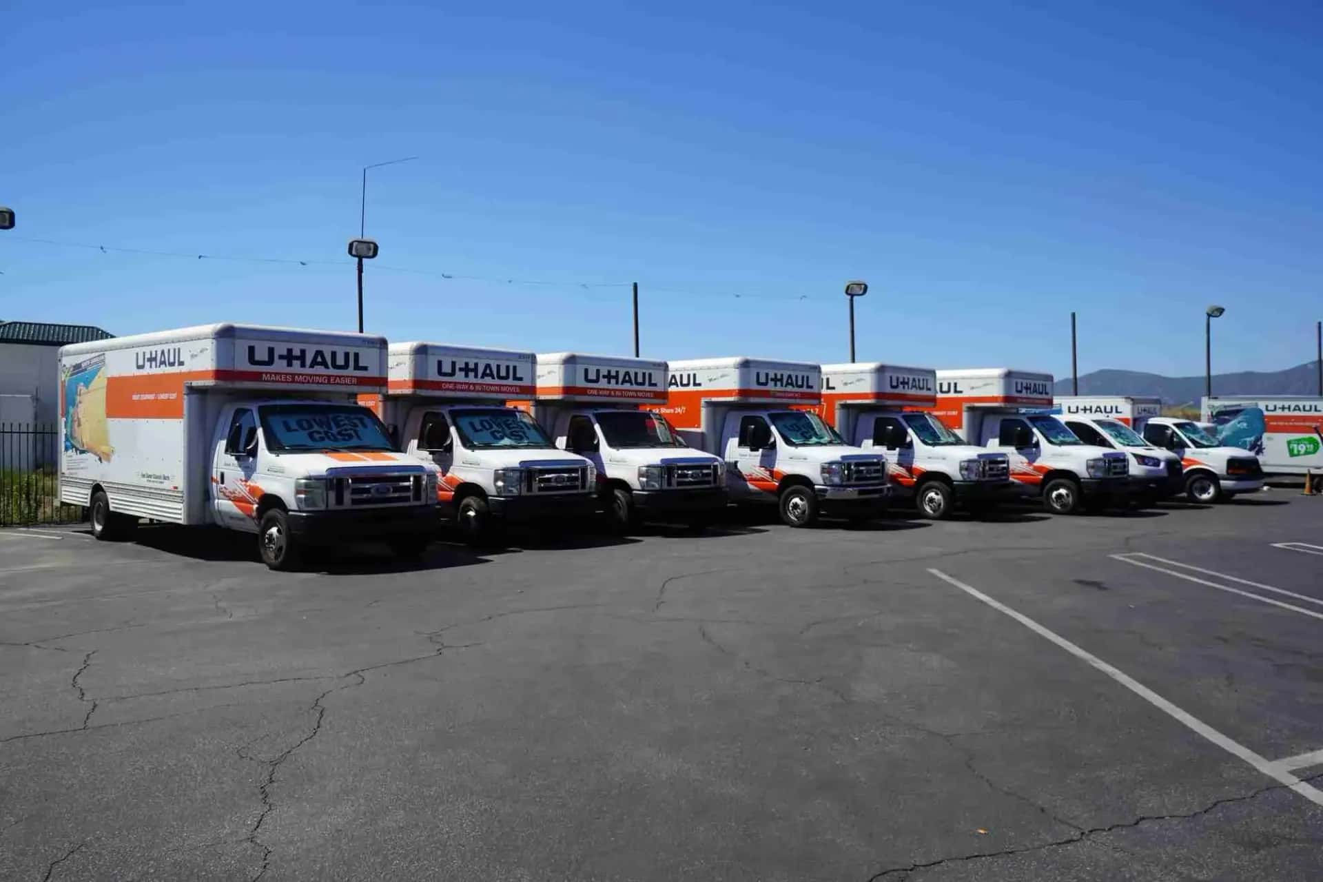 Row of U-Haul moving trucks parked on the lot in Upland