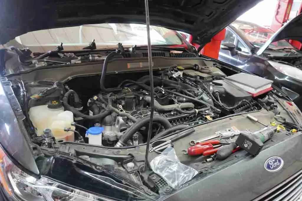 Engine bay with hoses and components visible during service