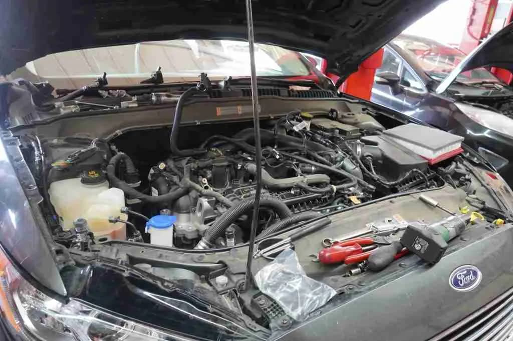 Engine bay with hoses and components visible during service