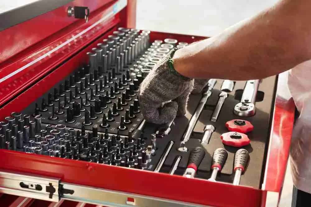 Technician selecting tools from a socket drawer