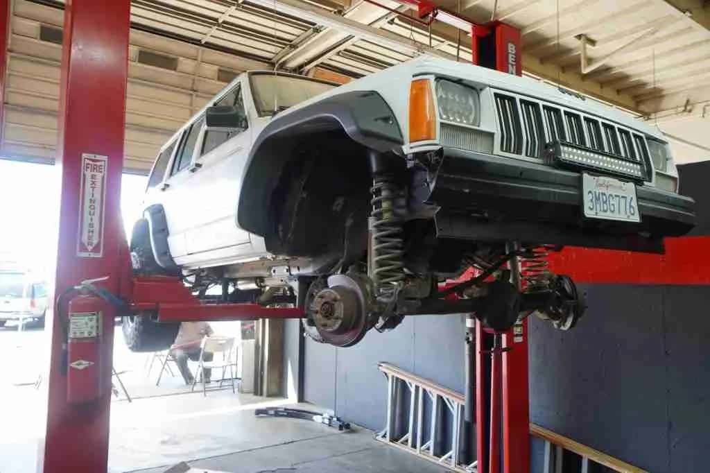 SUV on a lift with the front wheels removed