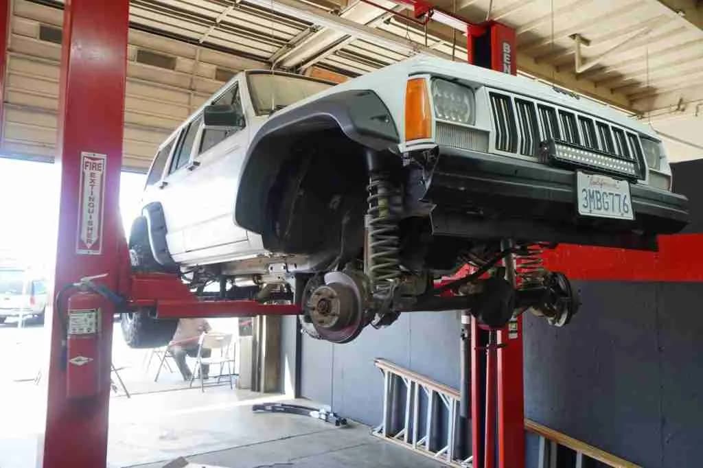 SUV on a lift with the front wheels removed
