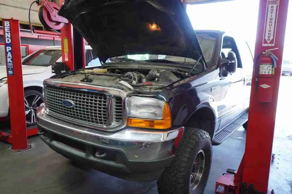 Pickup truck on a lift with the hood open