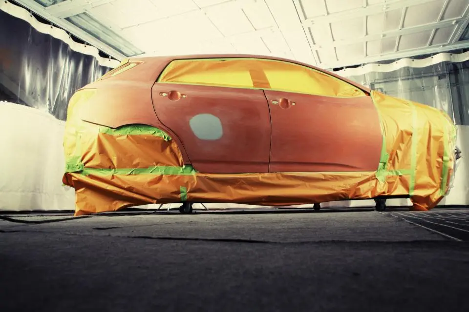 Car masked for paint work in a body booth