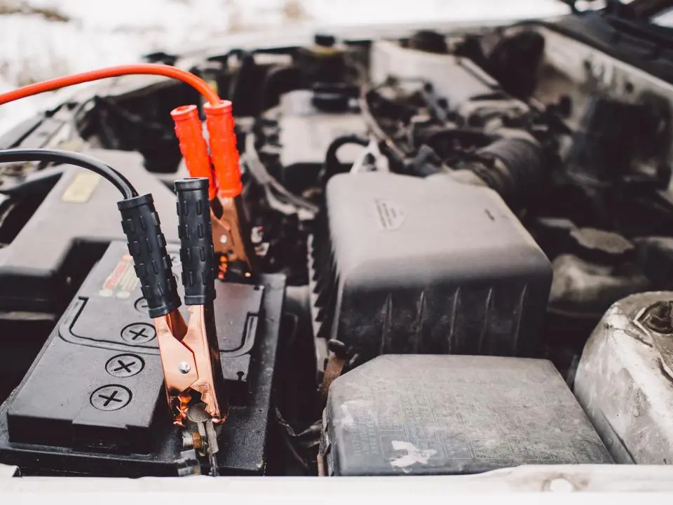 Jumper cables clamped to a car battery