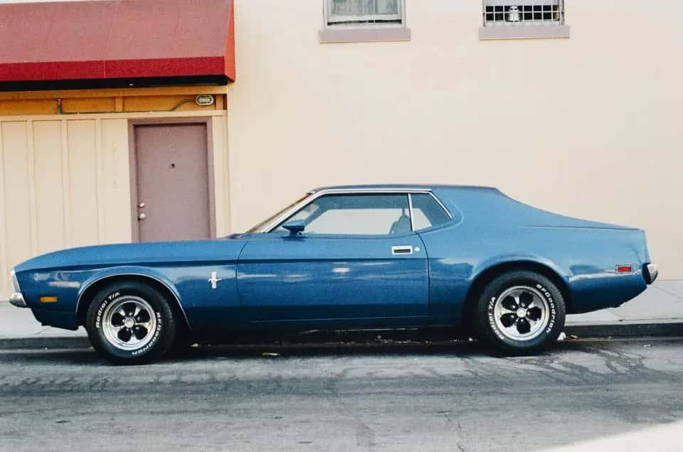 Blue classic Mustang parked on a street