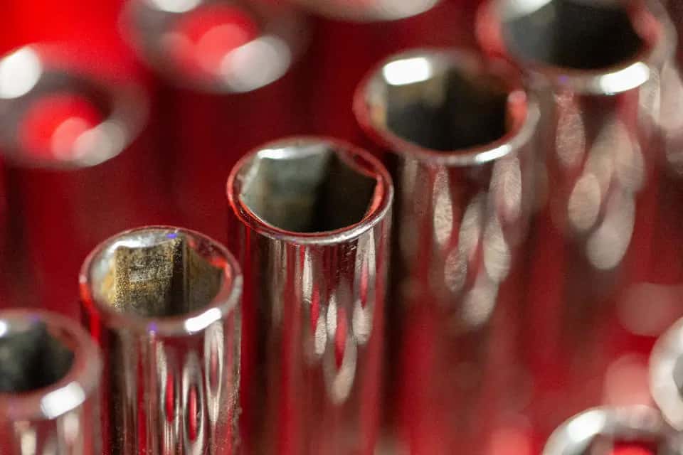 Chrome sockets lined up in a red tray