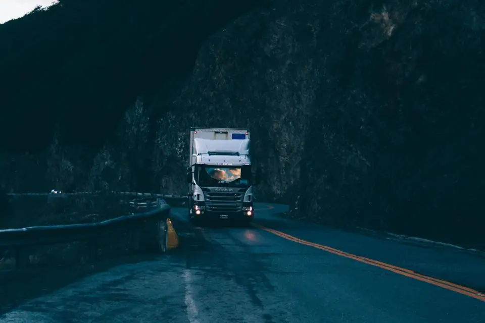 Truck driving on a dark highway