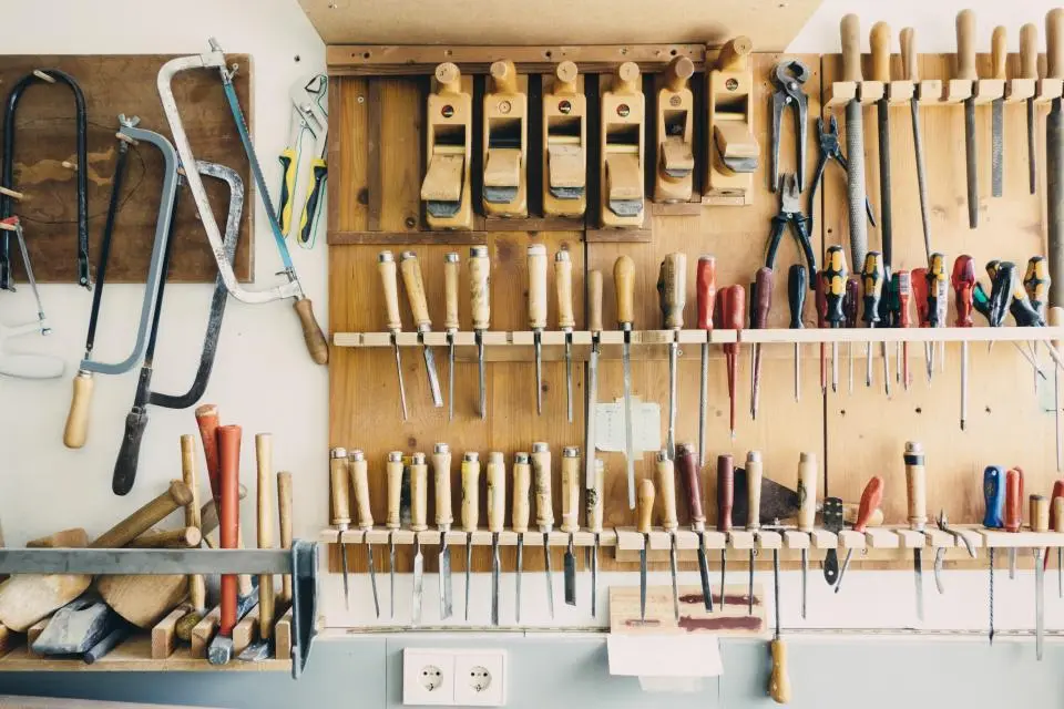 Wall of organized hand tools in a workshop