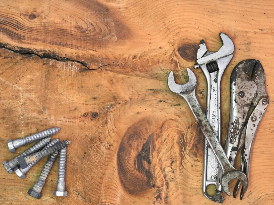 Wrenches and bolts on a wooden workbench